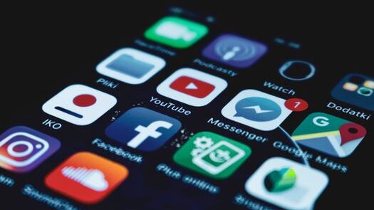 pexels-photo-5956083-5956083 Detailed close-up view of a smartphone screen displaying various popular social media app icons.